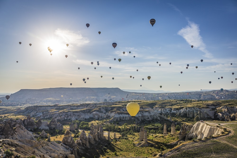 hot air balloons flying over city during daytime