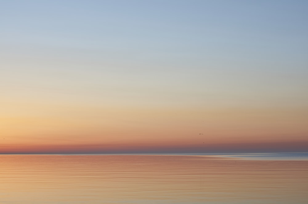 calm sea under blue sky during daytime