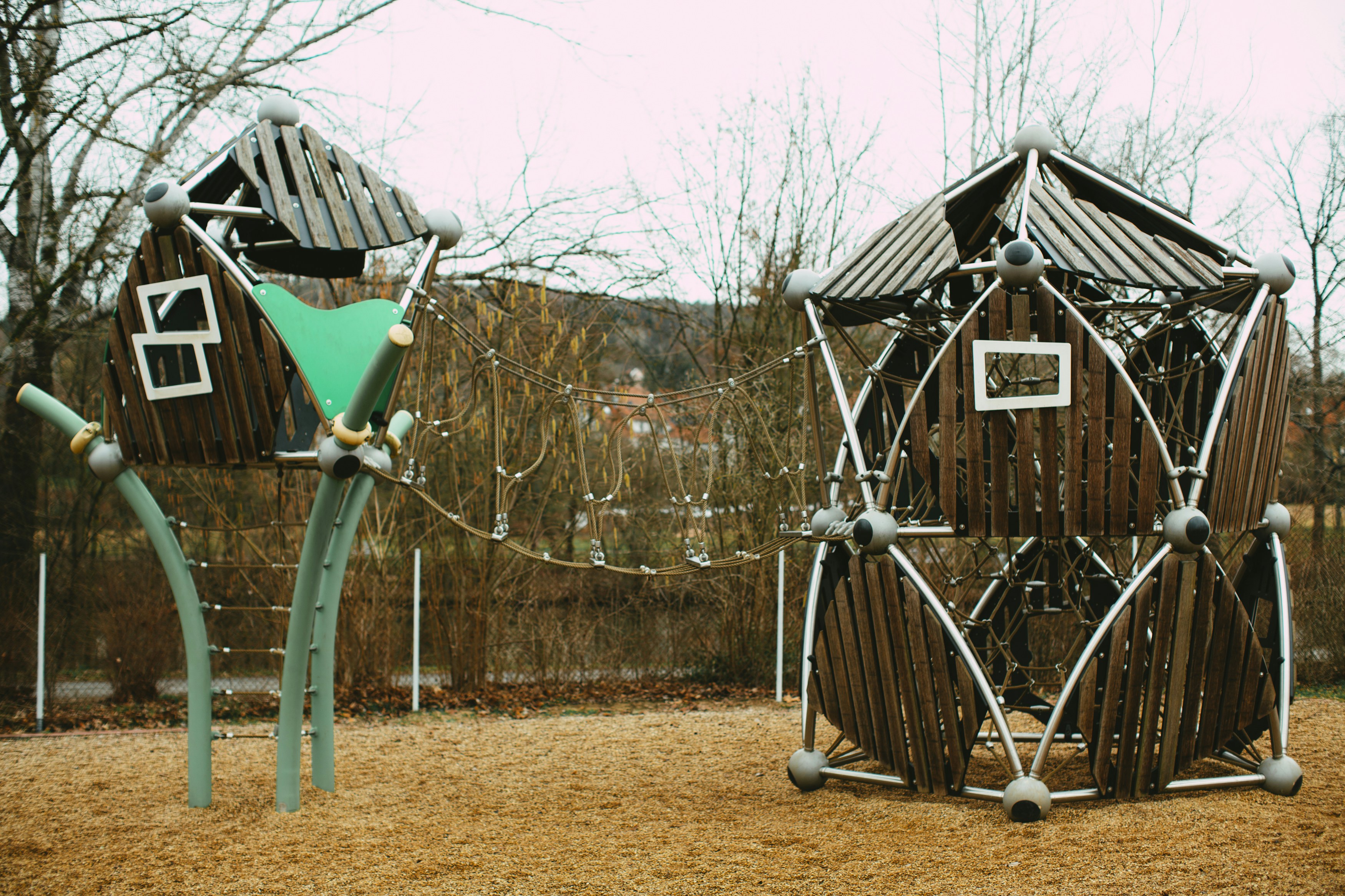 blue wooden swing near brown wooden house during daytime