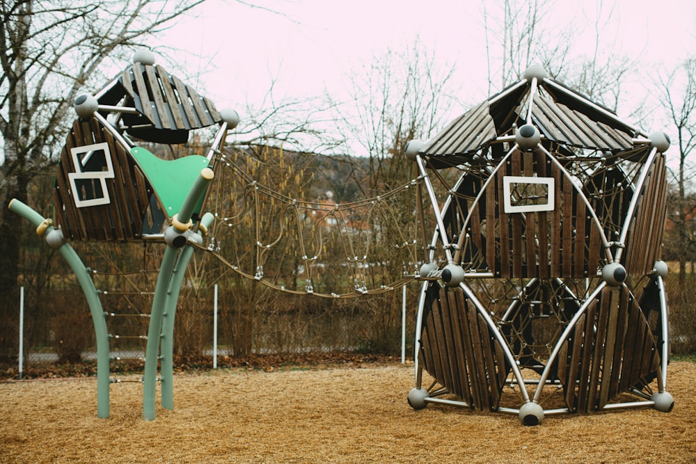 blue wooden swing near brown wooden house during daytime