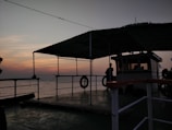 Guests on the deck of the dahabya watching the sky darken over the Nile.