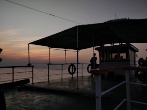Guests on the deck of the dahabya watching the sky darken over the Nile.