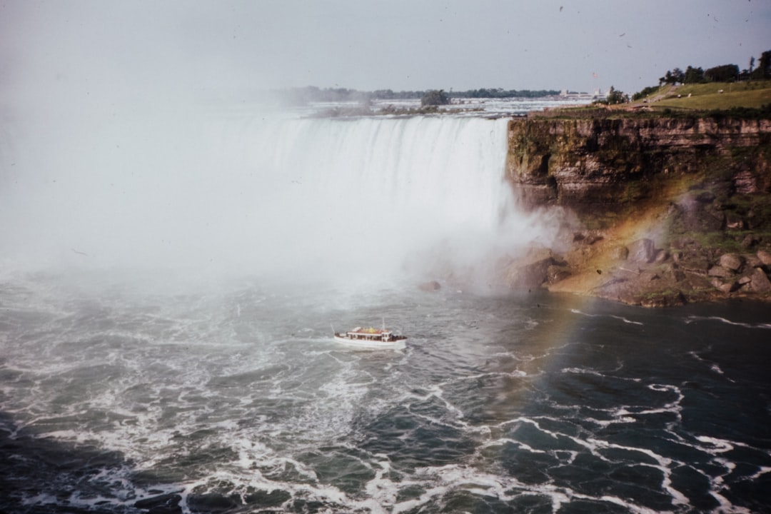 white boat on water falls during daytime