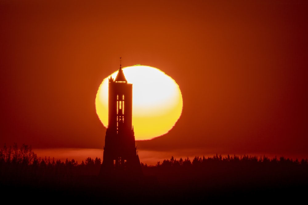 silhouette of tower during sunset