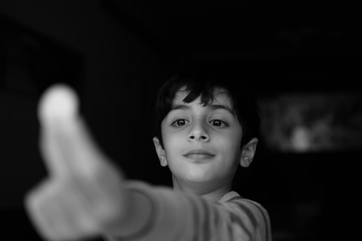 grayscale photo of boy in crew neck shirt
