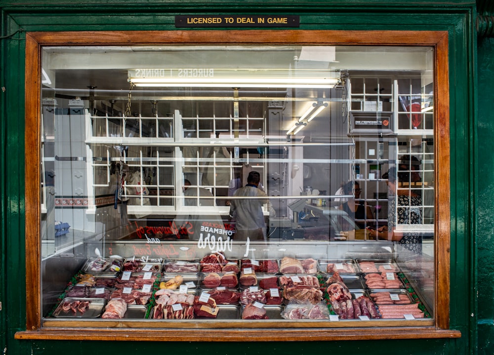 raw meat in clear glass display counter