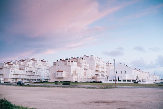 white concrete building under blue sky during daytime in Peniche Portugal