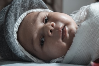 baby in white knit cap
