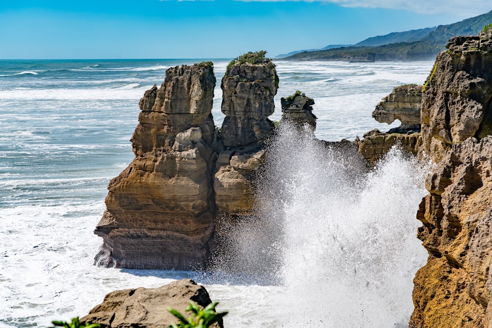 brown rock formation near body of water during daytime