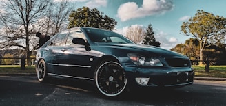 Sleek sedan parked on a scenic Luzern street under soft daylight.