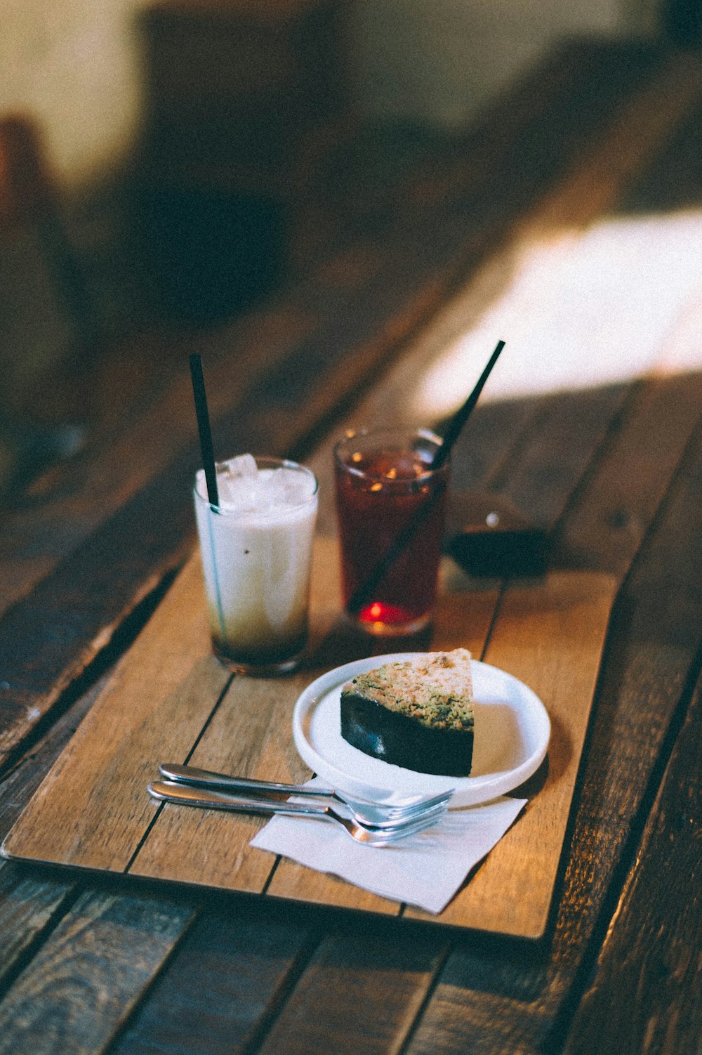 clear drinking glass with white liquid on brown wooden table