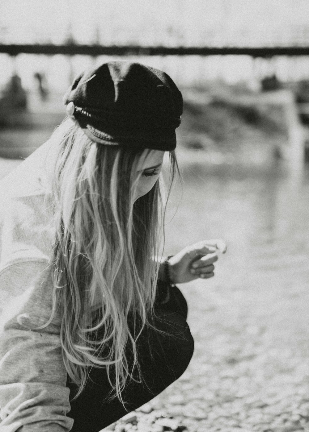 grayscale photo of woman in black long sleeve shirt holding her hair