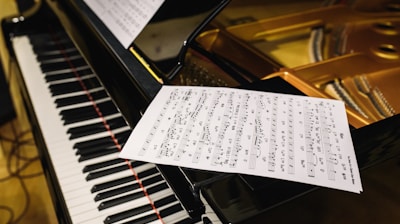 white paper on black piano