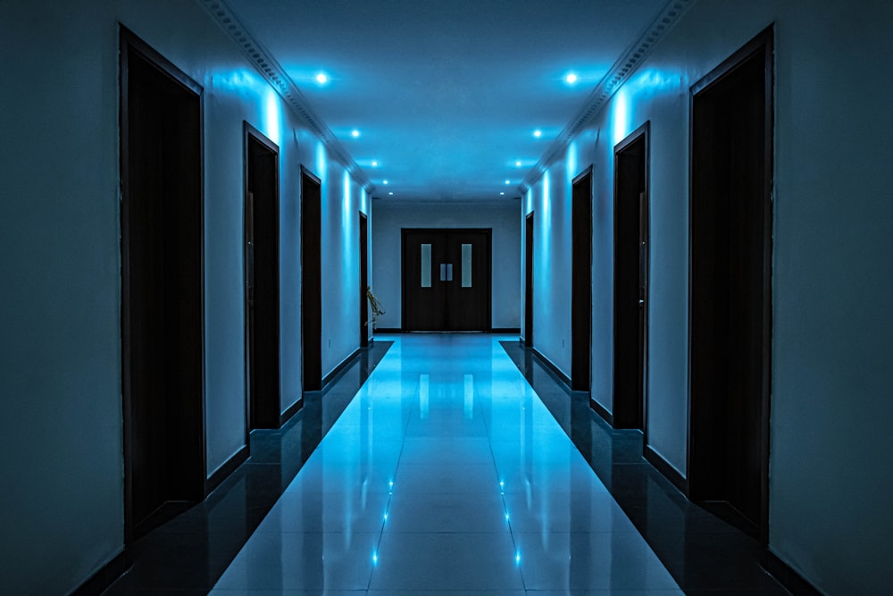 blue and white hallway with lights turned on in the middle