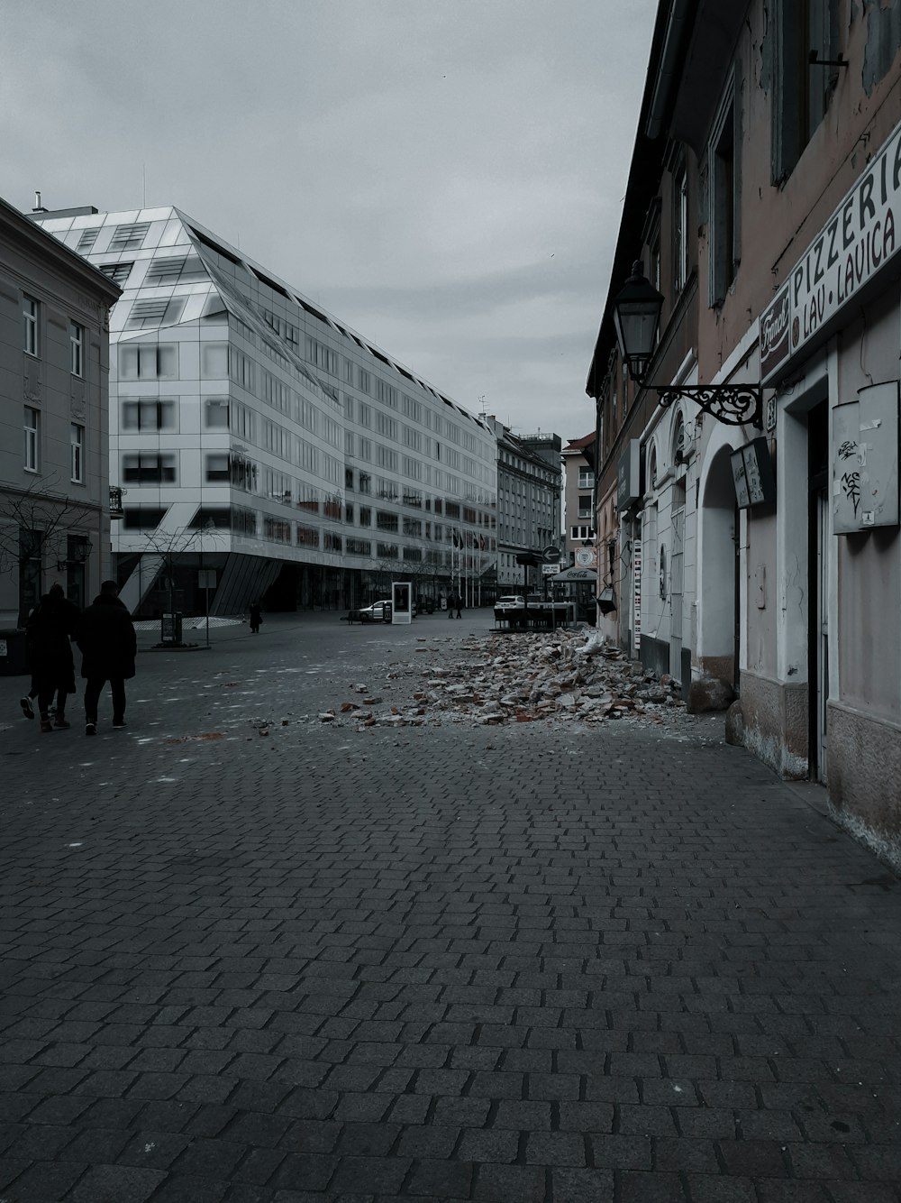 people walking on street between buildings during daytime