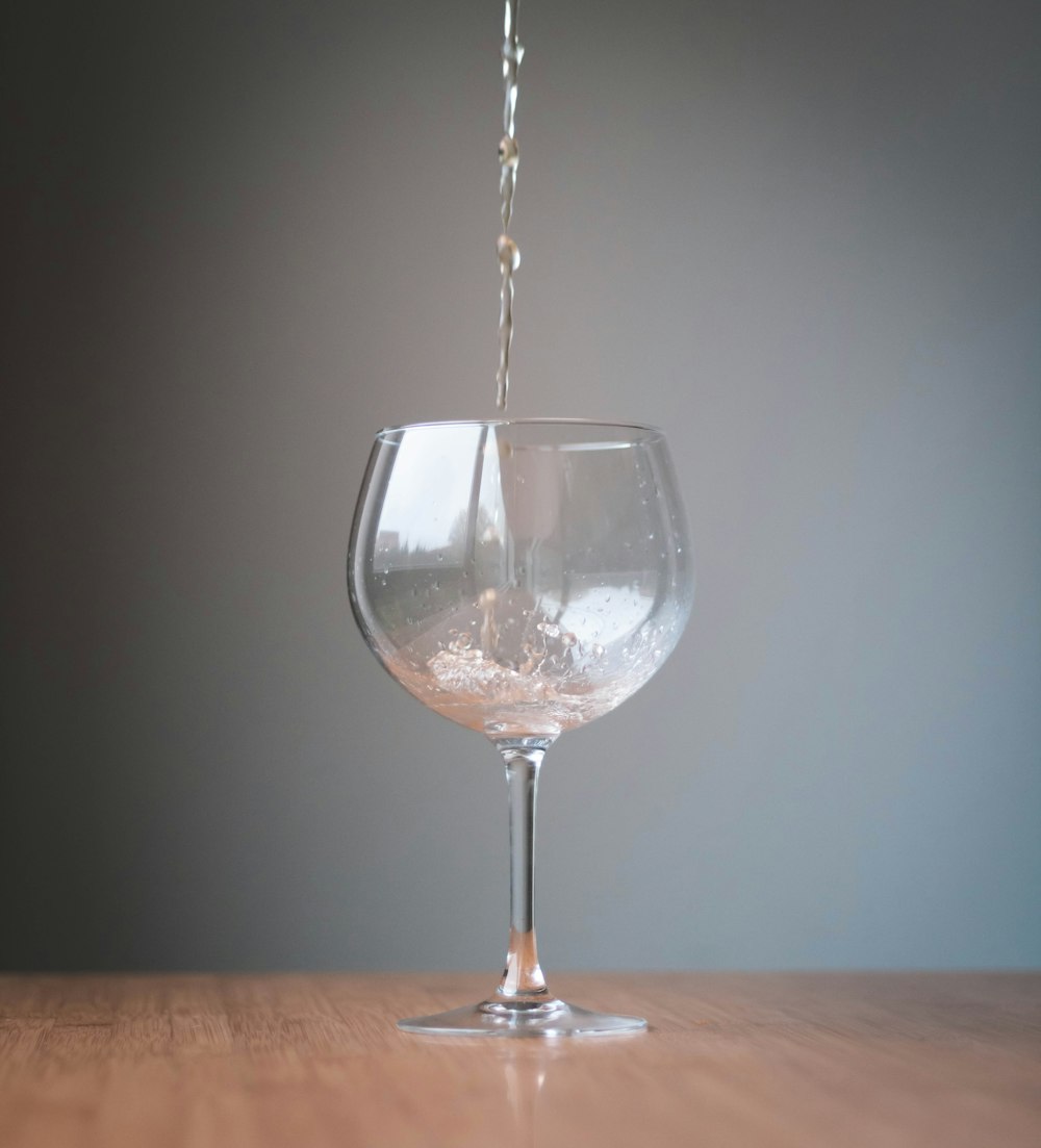 clear wine glass on brown wooden table