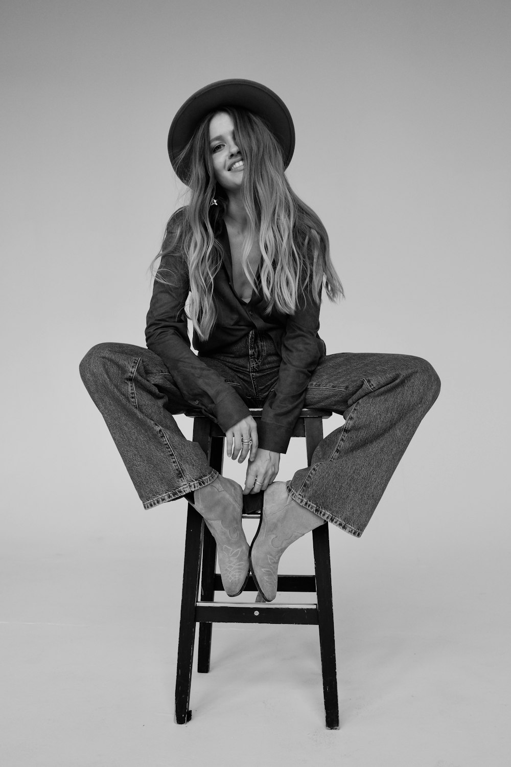 woman in gray coat sitting on chair