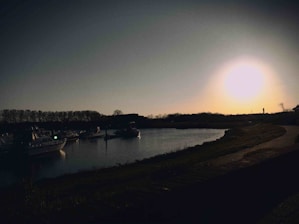 A peaceful dock at sunset with boats moored gently along the water.
