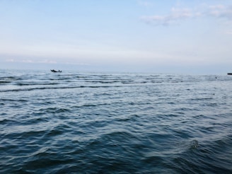 person riding on boat on sea during daytime