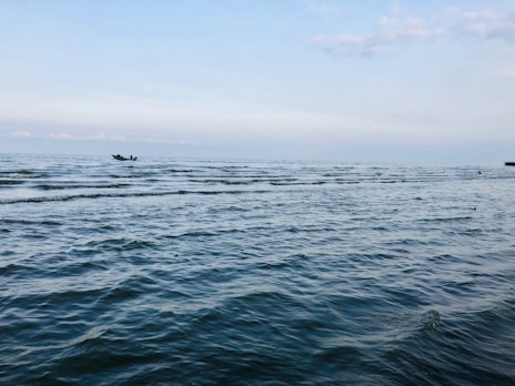 person riding on boat on sea during daytime
