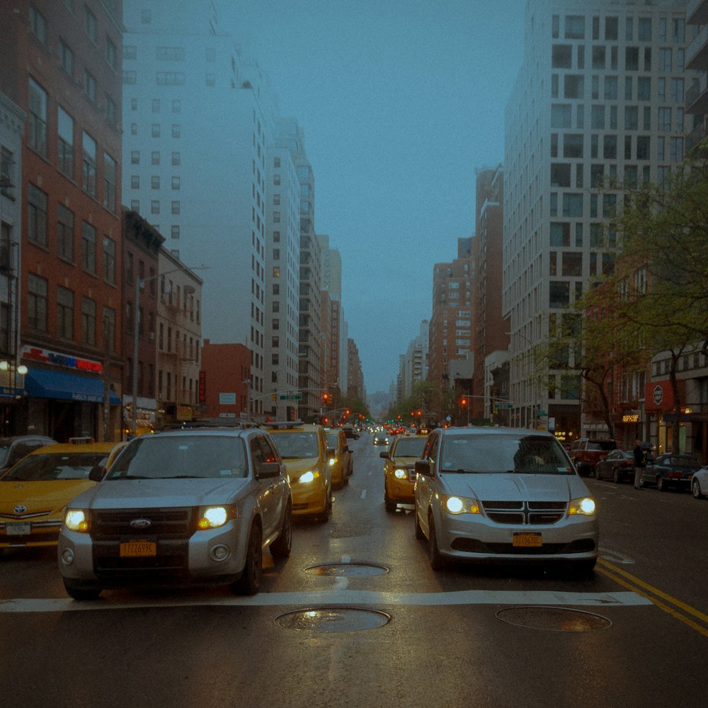 cars on road near high rise buildings during daytime