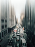 A busy city street with delivery vehicles in motion.