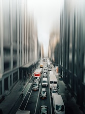 A busy city street with delivery vehicles in motion.