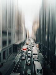 A busy city street with multiple delivery vehicles.