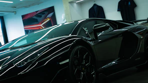 An ultra-luxury supercar parked in a minimalist, high-contrast showroom with dramatic shadows.
