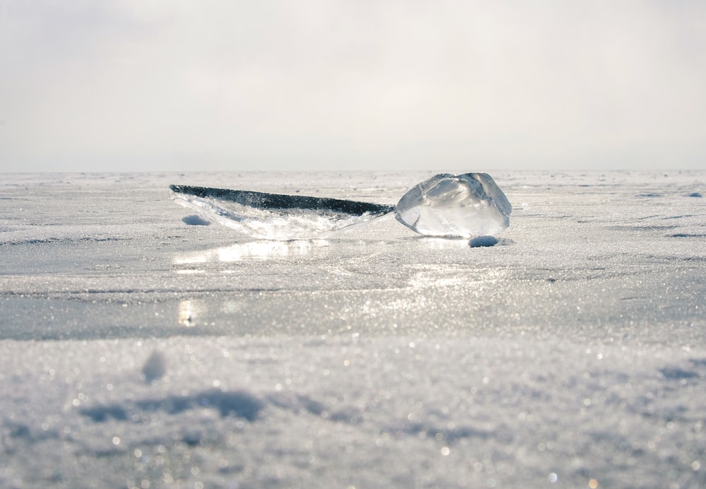 clear ice on gray sand