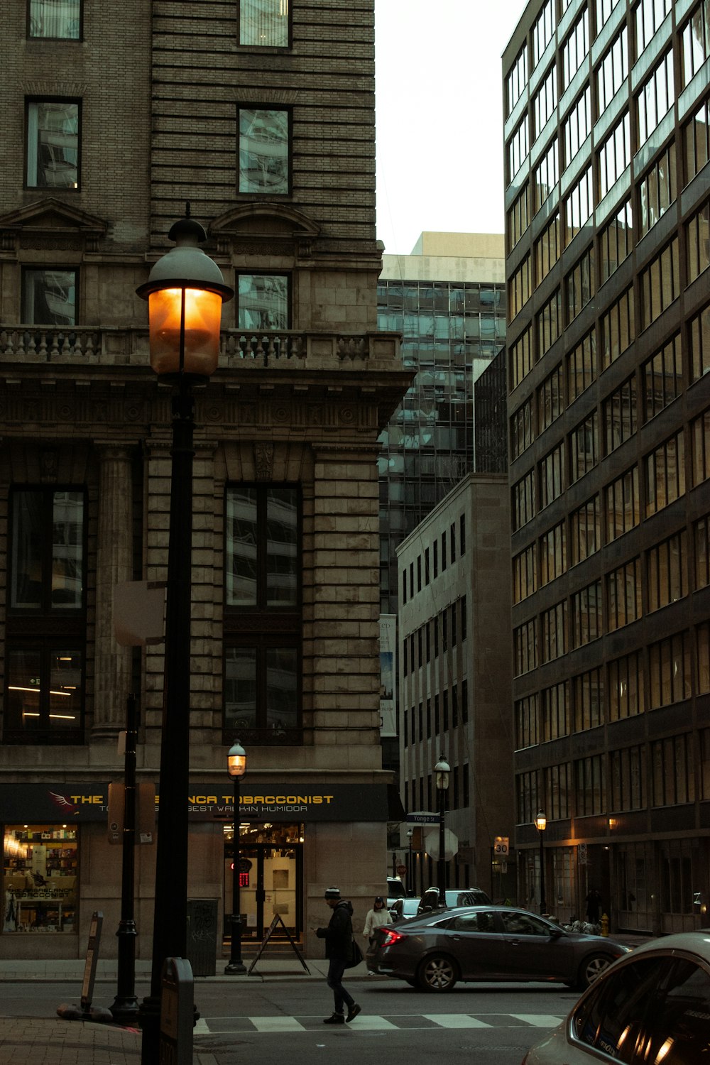 black street light near gray concrete building during night time