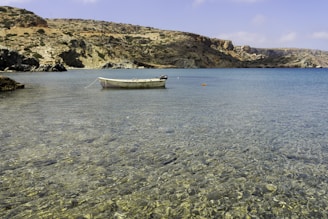 white boat on blue sea water during daytime