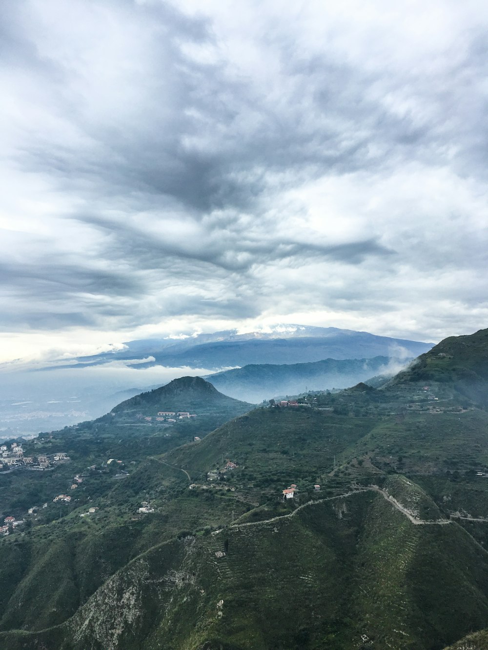 green mountains under white clouds during daytime