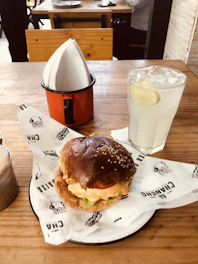 A rustic wooden table filled with a variety of handmade, hearty sandwiches and fresh ingredients.