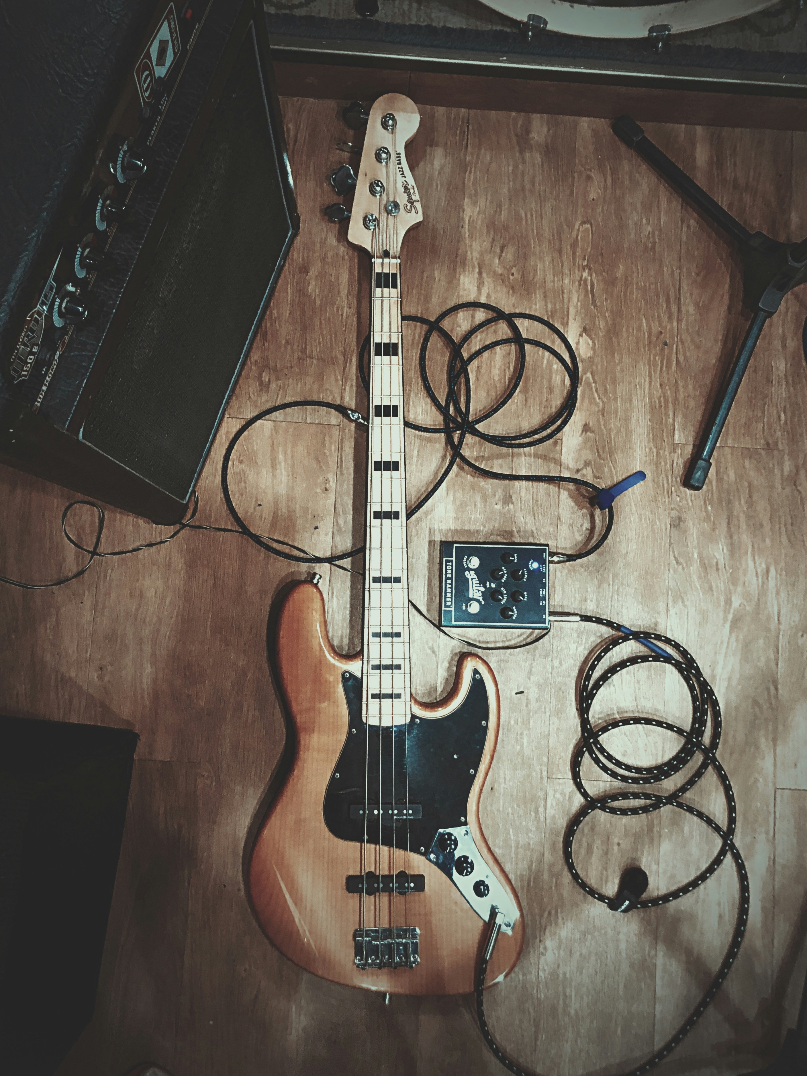 black and brown electric guitar beside black guitar amplifier