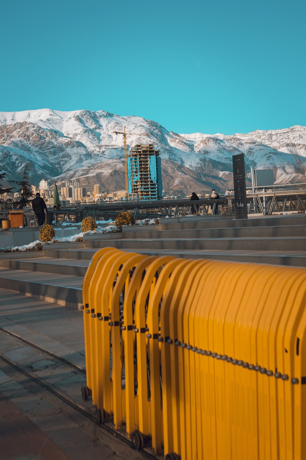 yellow plastic chairs on a bridge