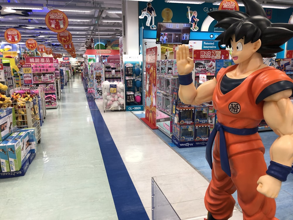 boy in orange and black t-shirt standing near shopping cart