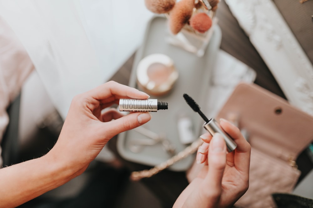 person holding black and silver pen