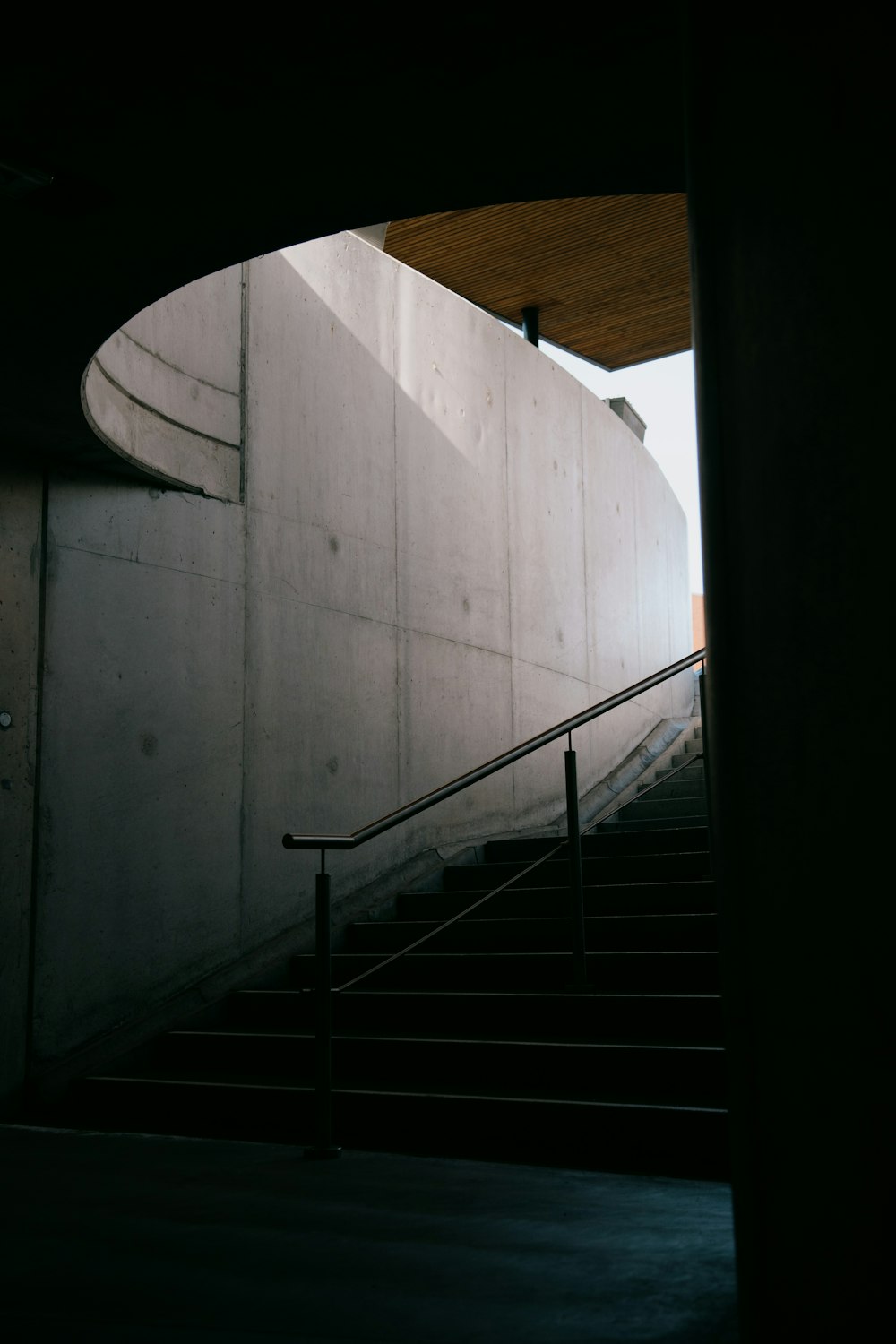 black metal staircase on white concrete wall