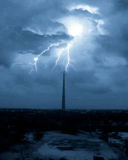 A striking illustration of The Tower card, lightning striking a tall tower against a dark, stormy sky.