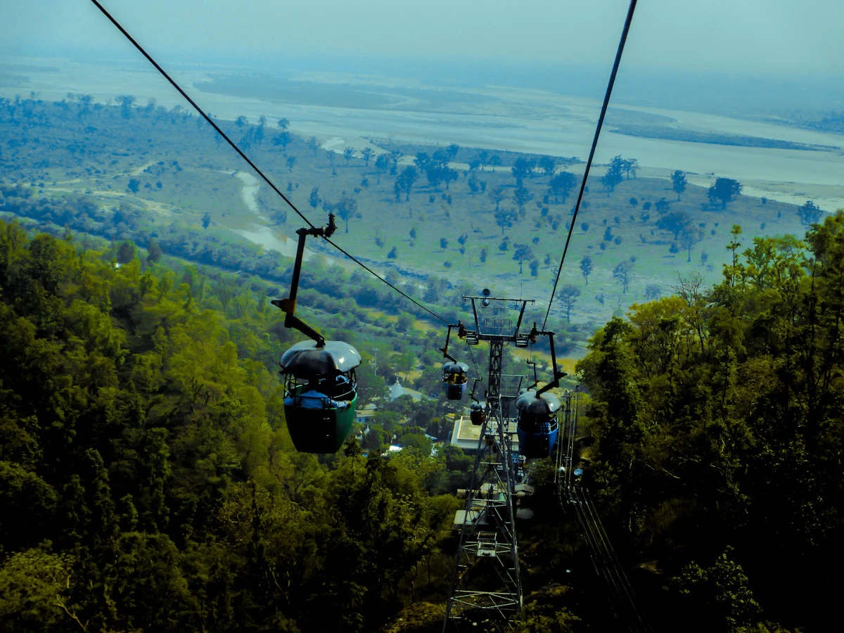Cable car ropeway over green forested hills near Dehradun
