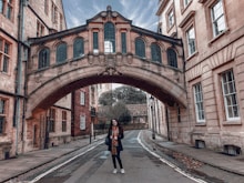 woman in black jacket walking on the street during daytime