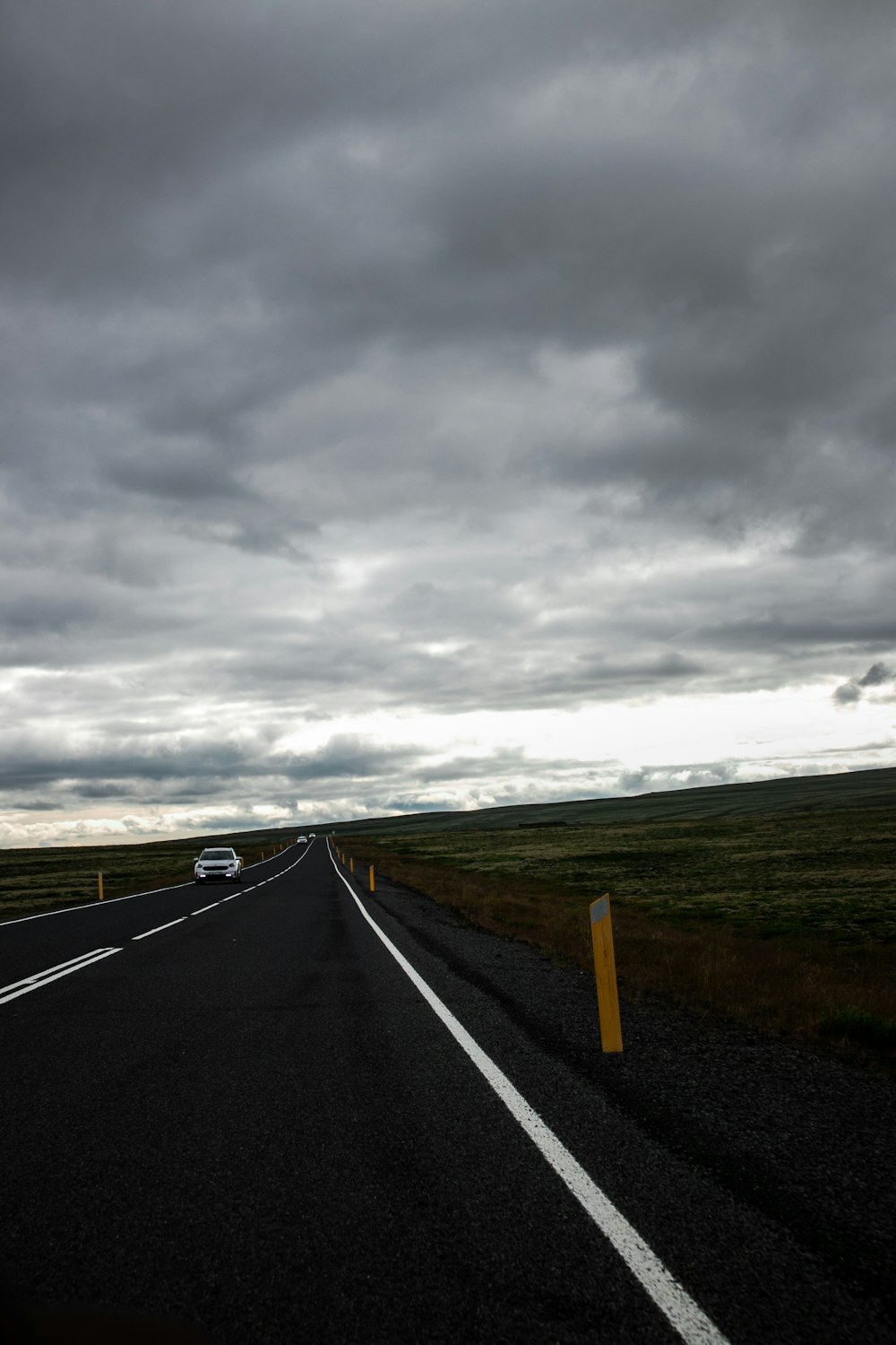 gray concrete road under gray clouds