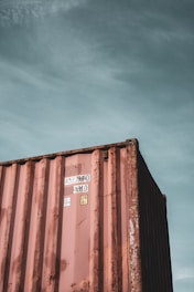 brown steel container van under blue sky during daytime