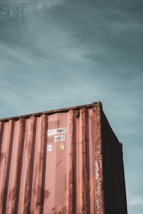 brown steel container van under blue sky during daytime