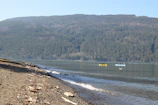 Kayakers paddling on a calm lake surrounded by Patagonian wilderness.