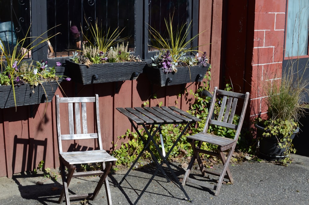 brown wooden folding chair beside green plants