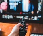 person holding black remote control