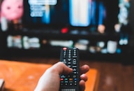 person holding black remote control