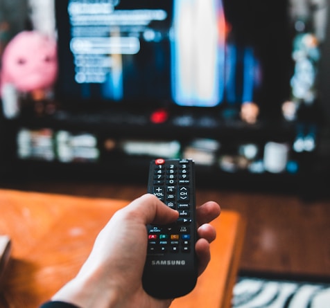 person holding black remote control